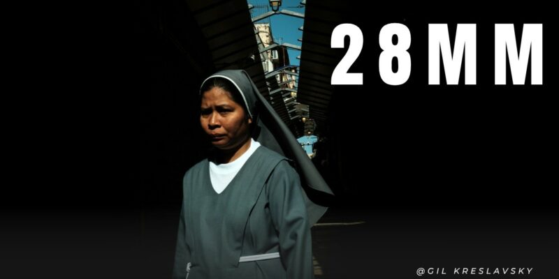 Why is street photography with 28mm lens difficult?